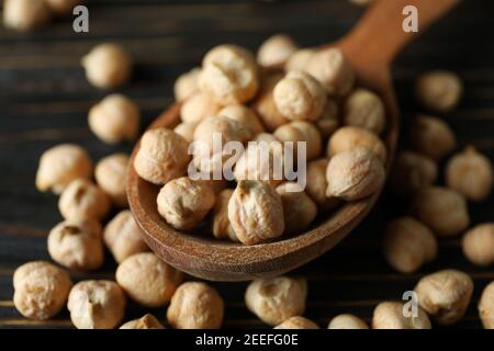 Spoon with fresh chickpea on wooden table Stock Photo