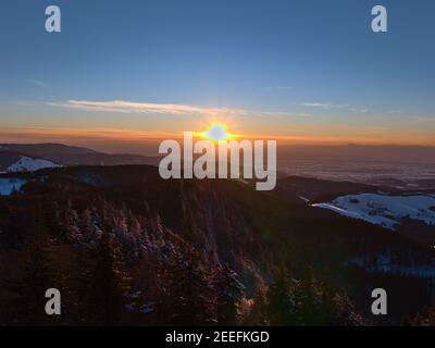 Stunning sunset viewed from Eugen-Keidel-Turm on the top of Schauinsland peak, Germany with beautiful view over the foothills of Black Forest. Stock Photo