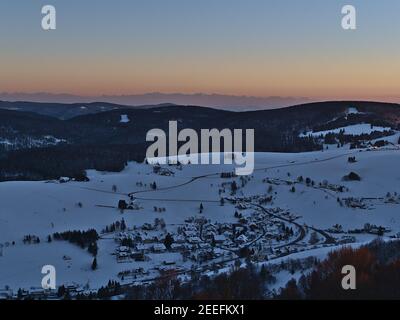 Stunning aerial view after sunset from observation tower Eugen-Keidel-Turm on Schauinsland peak over the south of Black Forest with small village. Stock Photo