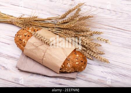 Freshly baked organic sourdough bread into sustainable paper bag Stock Photo