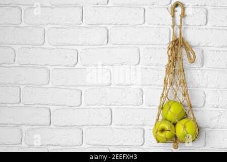 Ripe green apples in a light string bag Stock Photo