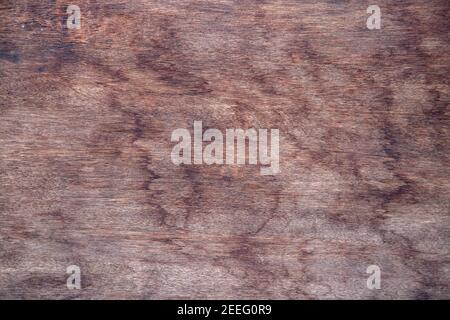 Weathered wooden surface texture. Red toned timber board closeup. Timber surface with weathered mark flat lay. Rustic wooden table top view. Grungy wo Stock Photo