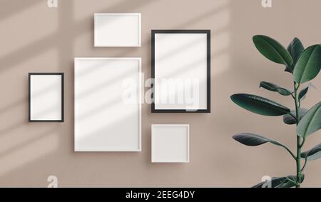 Various sizes of minimal photo frames mockup hanging on the apartment wall. Modern home interior design, blank empty frame template, nordic style Stock Photo