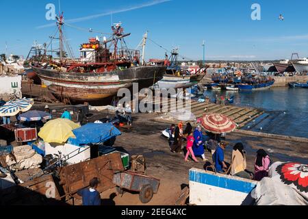 Essaouira, Morocco - April 15, 2016: Fisherman in the harbor at the city of Essaouira, with the the traditional fishing boats, in the Atlantic Coast o Stock Photo