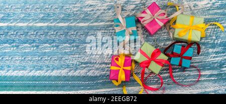 Gift boxes with origami ribbons. Blue turquoise background. Five gifts. Stock Photo