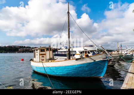 Stockholm, Sweden - August 9, 2019: Old blue fishing boat moored in the harbour Stock Photo