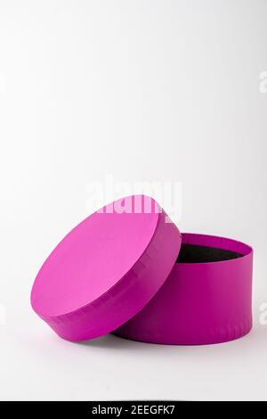 View of open purple round cardboard box, on white background, vertical, with copy space Stock Photo