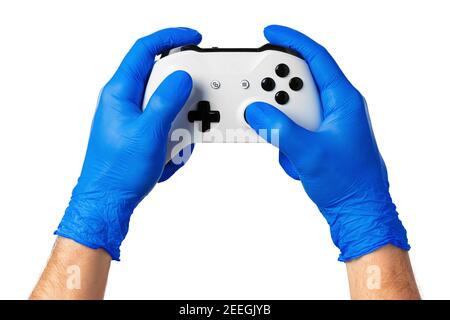 Video game console controller in gamer gloved hands. Games during isolation at home Stock Photo