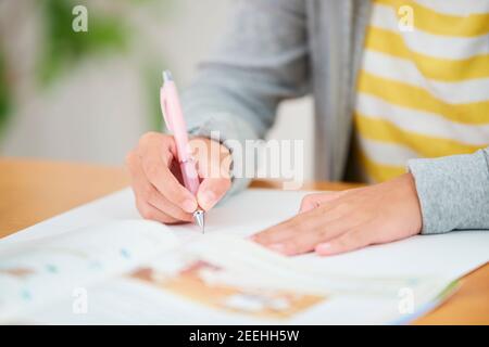 Japanese junior high schoolgirl studying remotely Stock Photo