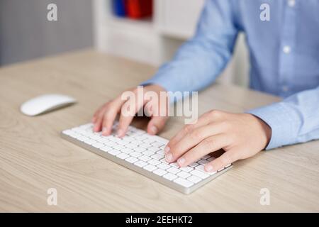 businessman using computer in office - close up of male hands on keyboard Stock Photo