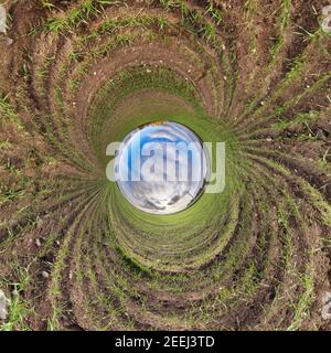 Blue little planet. Inversion of tiny planet transformation of spherical panorama 360 degrees. Spherical abstract aerial view. Curvature of space. Stock Photo