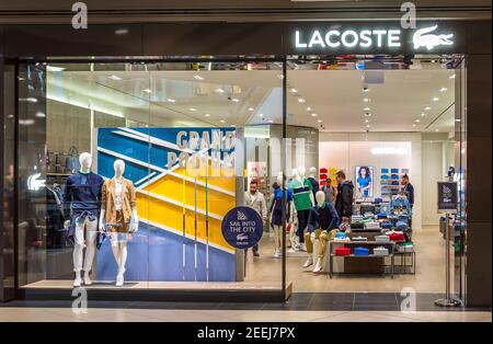 Lacoste sign logo at store entrance. Lacoste is a French company founded in that sells high-end clothing, footwear, many other items Stock - Alamy