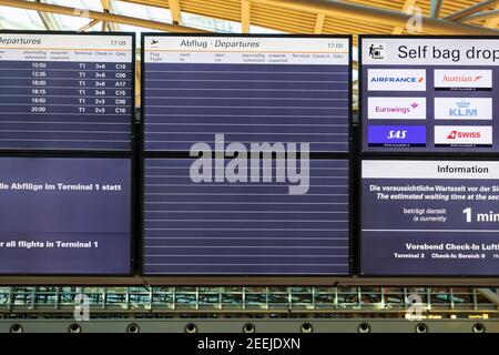 Close up of a partly empty departure board at airport in Hamburg, showing reduced schedule for flights because of coronavirus pandemic Stock Photo