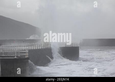 Aberystwyth Wales  16th Febuary 2021 . A stormy day on the west Wales coastline where people gathered to view giant waves lashing the seafront and promenade, Credit: mike davies/Alamy Live News Stock Photo