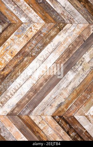 Wall decorated by wooden planks with peeled paint folded herringbone textured background Stock Photo