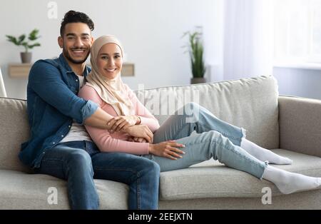Handsome arab man embracing his pretty wife, spending weekend together Stock Photo