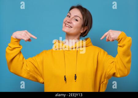 Young caucasian woman posing feels proud and self confident, pointing with fingers on herself. Example to follow. Studio shot Stock Photo