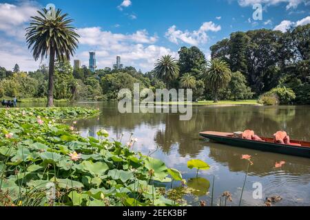 A view across the lake of the Royal Botanic Gardens, with the towers of the Melbourne in the background Stock Photo