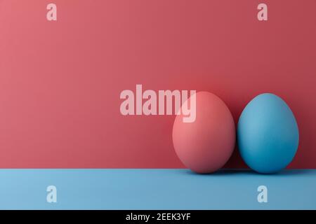 Painted Easter eggs on pink and blue background, copy space Stock Photo
