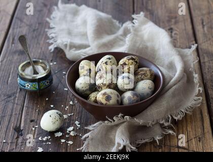 Boiled quail eggs on a wooden table, selective focus, rustic style, horizontal Stock Photo