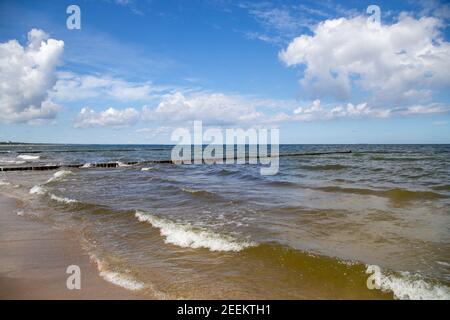 The lonely beach with waves and sun on the island of Usedom. Stock Photo