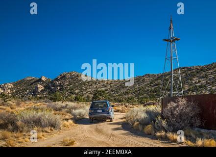 Subaru Forester at abandoned water tank in Caruthers Canyon, New York Mountains, Mojave National Preserve, California, USA Stock Photo