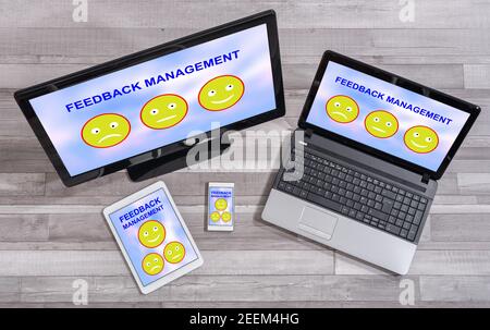Feedback management concept shown on different information technology devices Stock Photo
