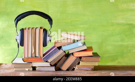 audio book concept with large heap of books and vintage headphones,literature,entertainment,education, good copy space Stock Photo