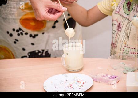 Mom and child together themselves cooking of cake pops. Home cooking, family concept, handmade food Stock Photo
