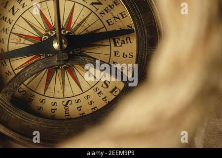 Ship rope and compass on wooden background Stock Photo