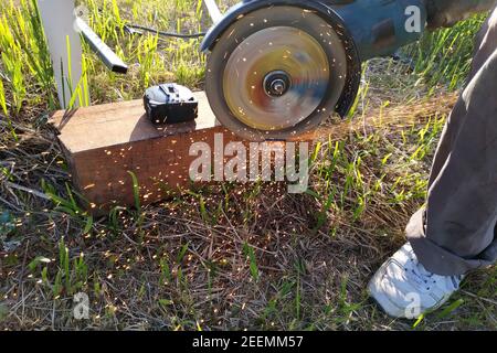 Cutting bricks with an angle grinder, construction work, the process of execution close-up.new Stock Photo