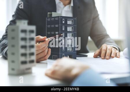 real estate developer and architect discussing new housing development project in office Stock Photo