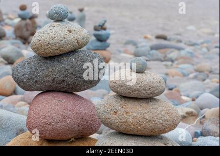 Oxbow Park along the Sandy River in Oregon the rocky shoreline invites visitors to add to the locals favorite passtime of stacking rocks. Stock Photo