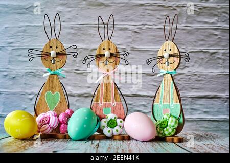 Three wooden Easter bunnies with decoration. Stock Photo