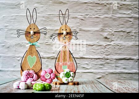 Two wooden Easter bunnies with decoration. Stock Photo