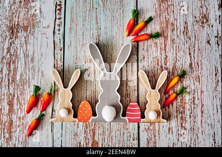 Three wooden Easter bunnies from behind with decoration. Stock Photo
