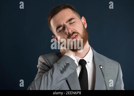 White collar worker having severe neck pain wearing a black tie Stock Photo
