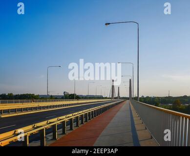Red and gray pavement on huge Millennium bridge in Wroclaw Stock Photo