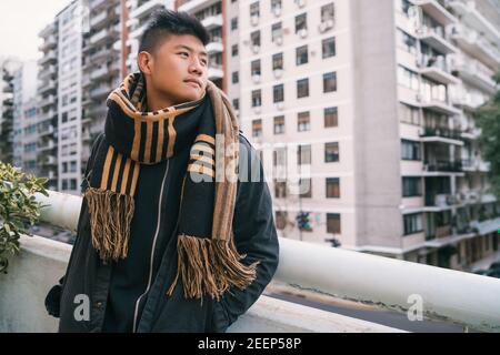 Portrait of young Asian man outdoors. Stock Photo