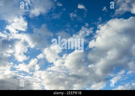 Clouds moving on blue sky forming a storm. Stock Photo