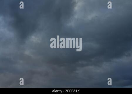 Dark stormy clouds moving on sky. Rain and hail. Stock Photo