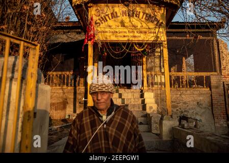 A Kashmiri pandit devotee looks on as he walks out of the Shital Nath Temple which was reopened after 31 years.The temple was closed in the early 90s following the migration of Pandits from the valley in the wake of militancy. Stock Photo