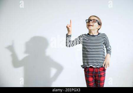 Quirky Kid Wearing Black Glasses Eager With An Idea To Share Stock Photo