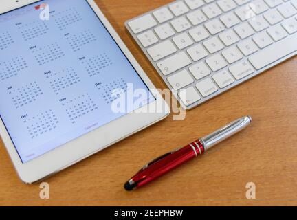 Electronic calendars and computers with open calendars Stock Photo