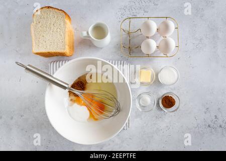 Minimal style flat lay of ingredients for making french toast (or wentelteefjes in Dutch) on white grey background, view from above Stock Photo