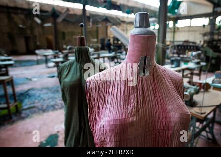 Close up of a pink and green faded tailor's dummies in an old and abandoned Italian textile factory Stock Photo