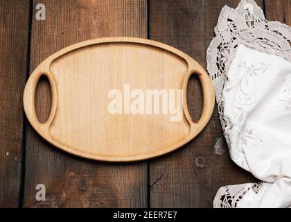 empty oval brown wooden tray board on a wooden background, top view Stock Photo