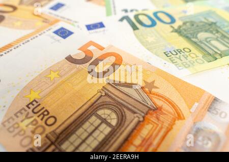 Banknotes background. Fifty and one hundred Euro notes in orange and green color covering the floor. Currency of Europe. Stock Photo