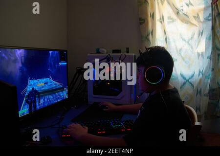 Teenager Boy Online Plays A Computer Game With Headphones And A