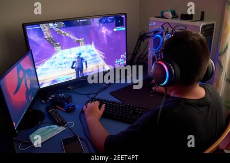 Teenager Boy Online Plays A Computer Game With Headphones And A